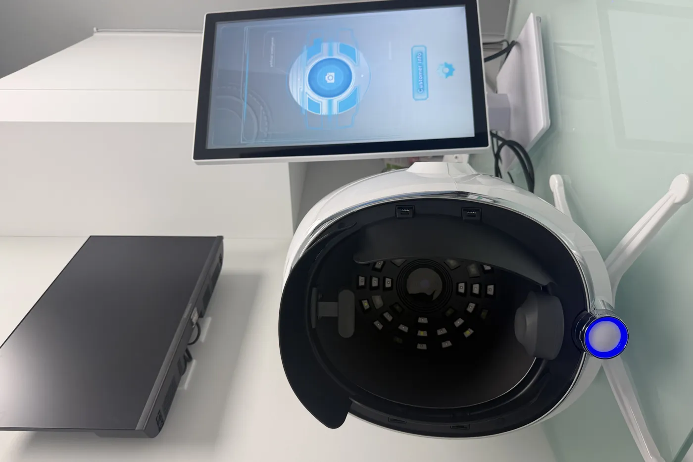 Close view of the skin analyzer's imaging hood and touchscreen